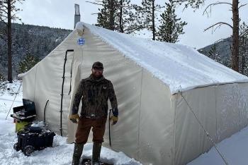 camper in front of their tent